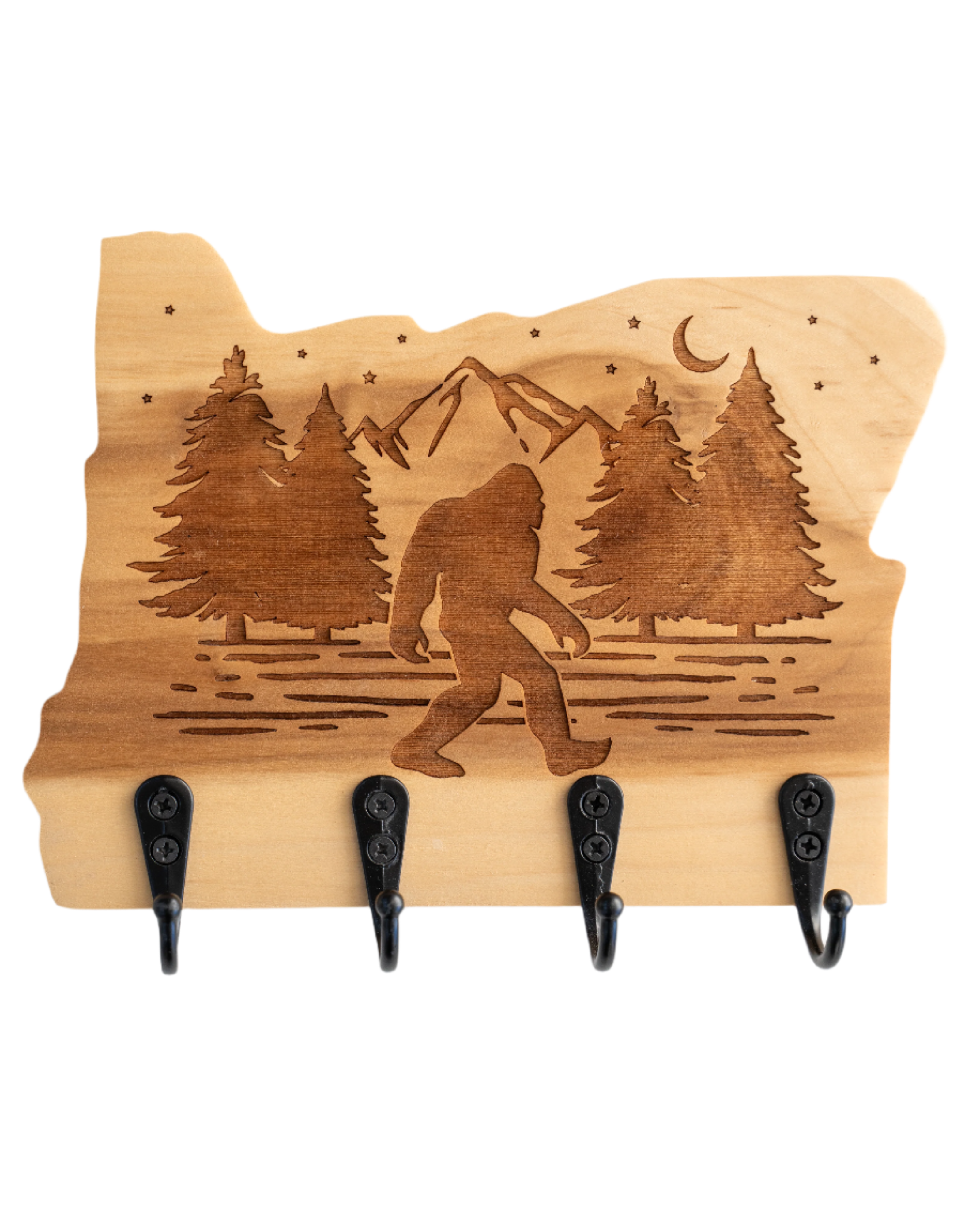 A wooden wall hanger with a silhouette of Oregon state and an engraved Bigfoot figure, featuring black hooks.